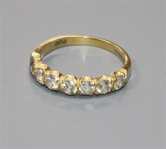 A modern 18ct gold and seven stone diamond half hoop ring, size O.